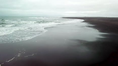 haunting beautiful aerial over a black sand beach in southern iceland 3