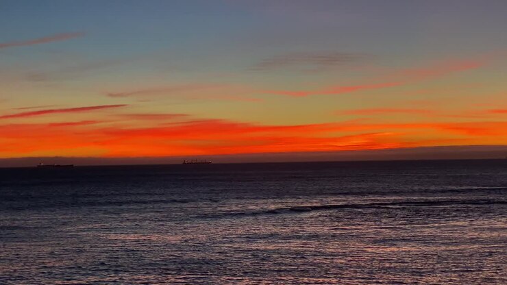 Lisbon Portugal wide shot 4K, aerial view city skyline sunset over ocean timelapse at Cascais district