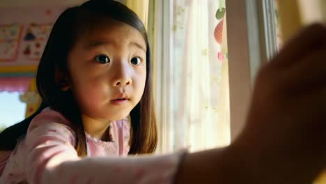 child looking out a window