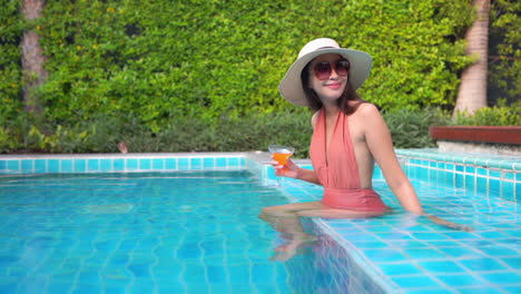 crazy rich asian model on a luxurious vacation in pool