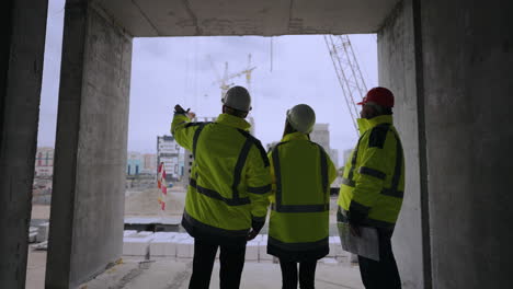 professional workers on construction site foreman and architects are viewing building under construction