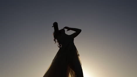 silhouette of girl dancing in sunset