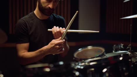 artist preparing to concert in hall. musician hitting drumsticks in studio.