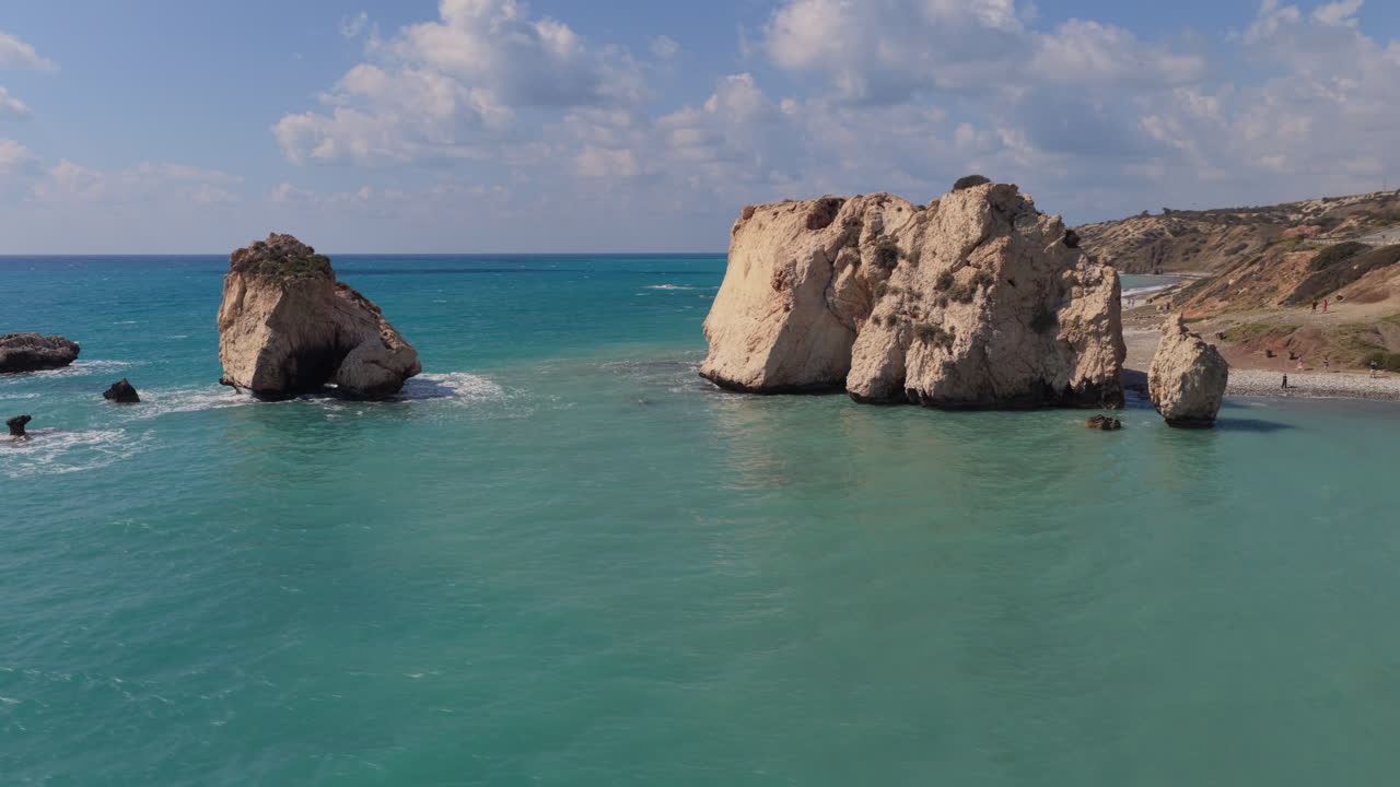 Aerial drone view of Aphrodite's Rock coastline with turquoise water and rugged cliffs along the Mediterranean shore