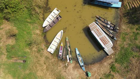 A-revealing-footage-of-a-boat-station-with-a-Boat-Tour-leaving-during-a-summer-day-in-Bueng-Boraphet,-Nakhon-Sawan,-Thailand