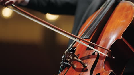 cellist is playing cello closeup view of bow and strings classic music concert or rehearsal