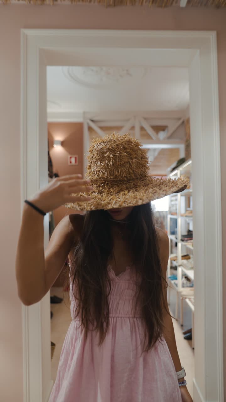 Woman in pink dress and straw hat