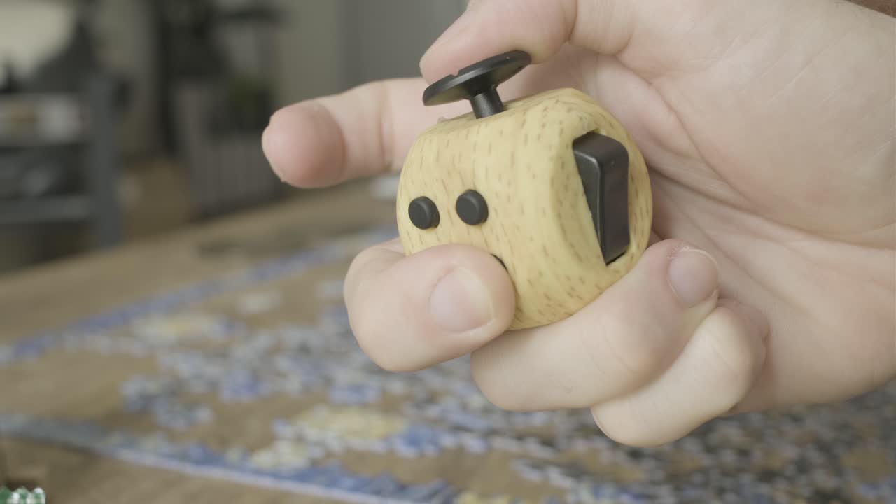 Hands playing around With a Fidget cube toy