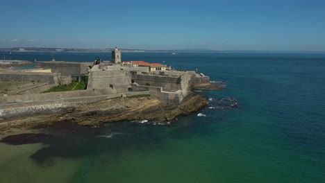aerial drone panoramic view of sao joao fort at carcavelos beach, near lisbon, portugal