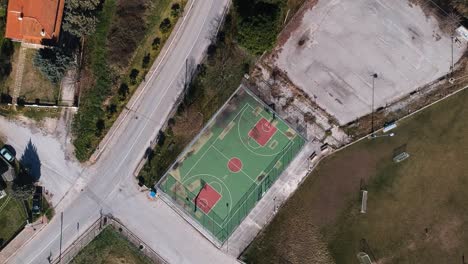 rotating overhead aerial clip over a basketball court in a sports complex in choristi village in drama greece