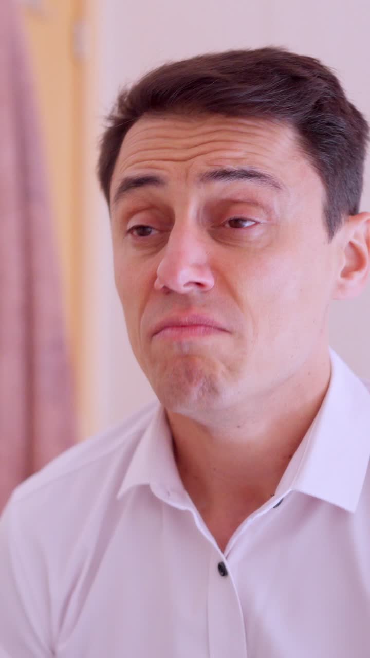 Sick man blowing nose while looking in mirror