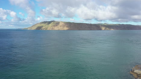 Flight-from-Huia-beach-towards-Manukau-Heads,-Auckland,-New-Zealand,-aerial-shot