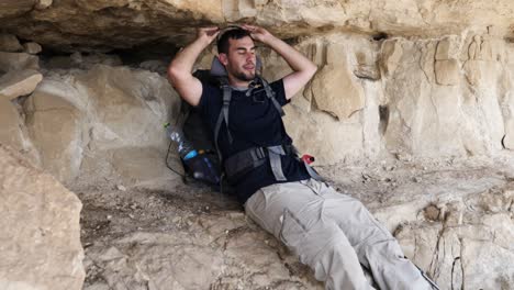 A-young-person-removing-his-sunglasses-and-relaxing-in-mountain