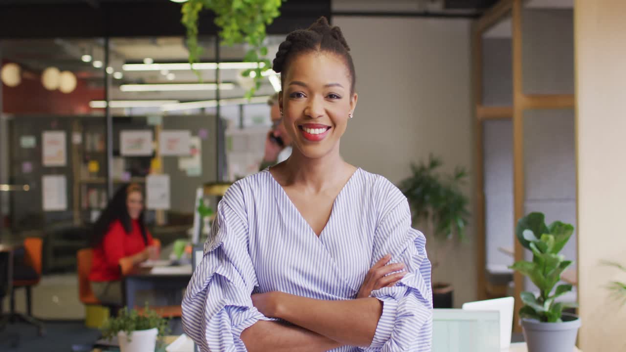 retrato de una feliz mujer de negocios afroamericana mirando a la cámara en la oficina