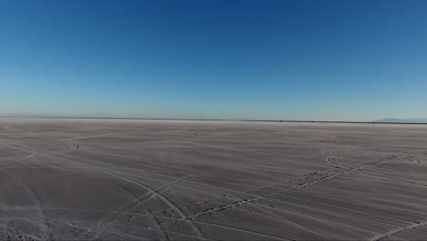 flying over the bonneville salt flats in northwestern utah reveal white salt and tire tracks