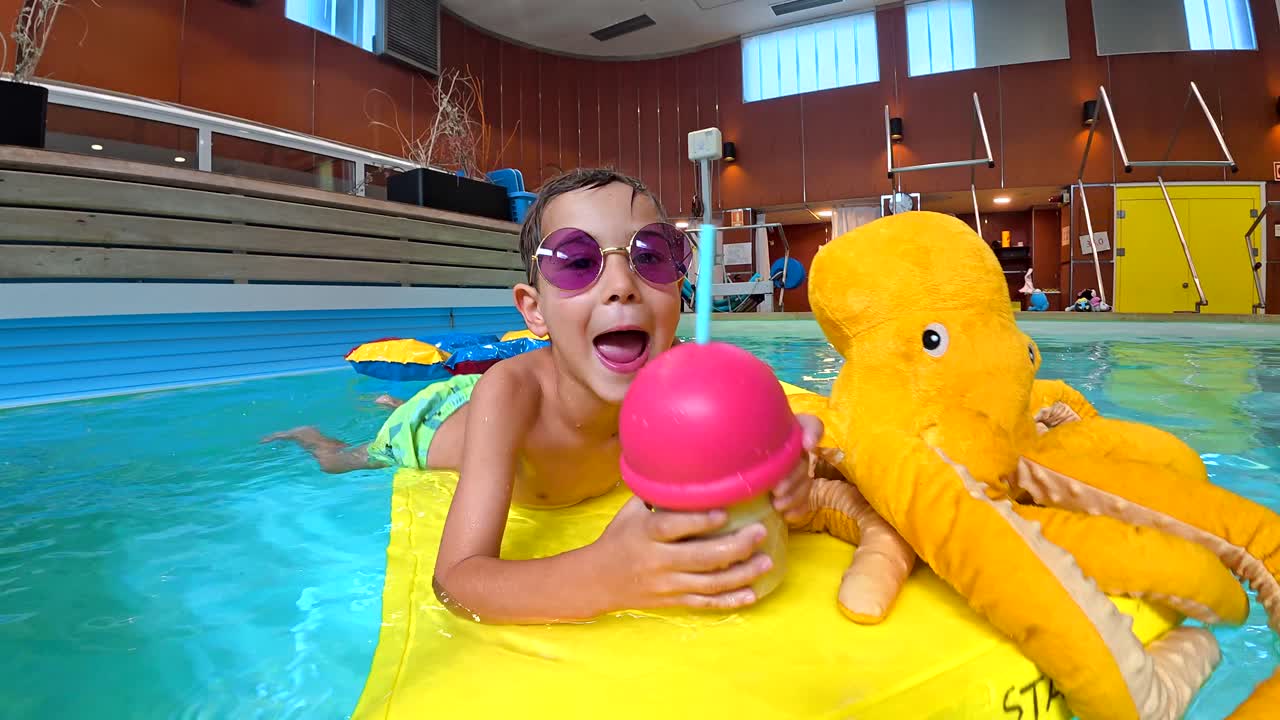 Boy with Octopus Toy in Pool