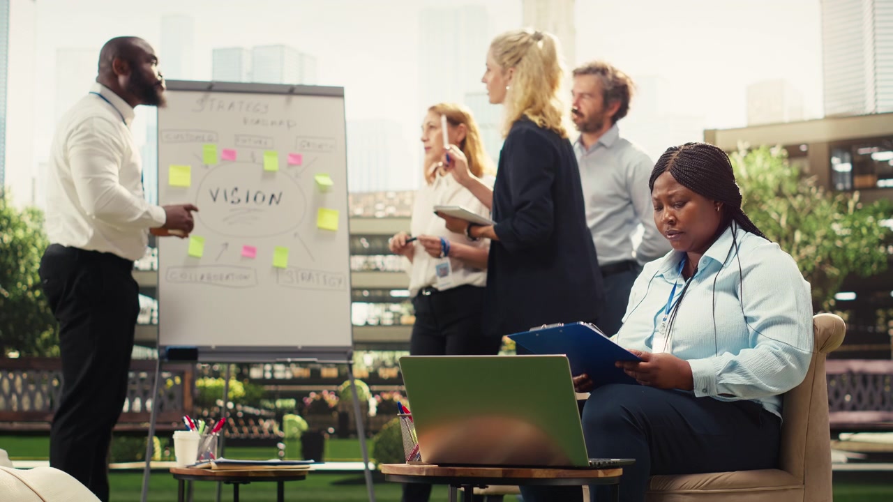 Business Professional Working on Laptop During Team Meeting