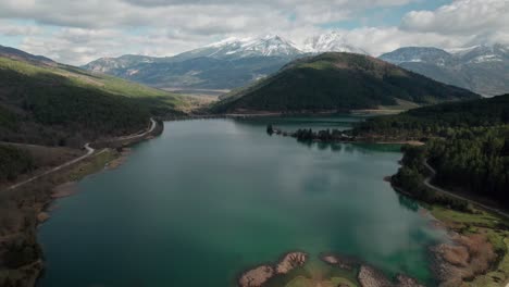 Paradisiac-Landscape-of-Lake-Doxa-in-Greece,-European-Turquoise-Calm-Waters-surrounded-by-Pine-Forest-Hills,-Travel-and-Tourism-Destination