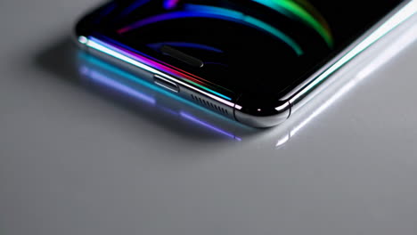 close-up of a modern smartphone with colorful reflection