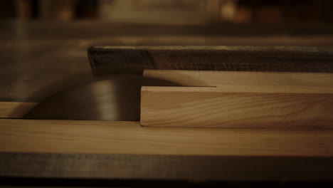 man working with saw machine in studio