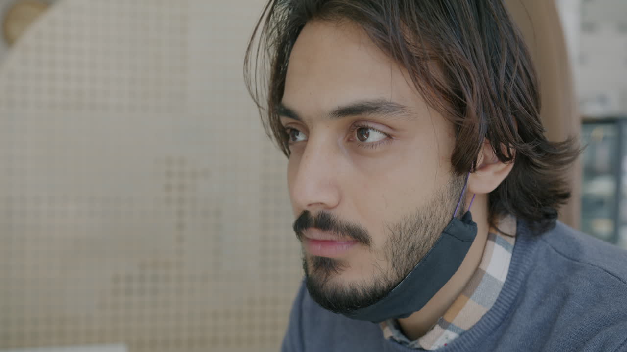 Man Wearing Mask in a Cafe