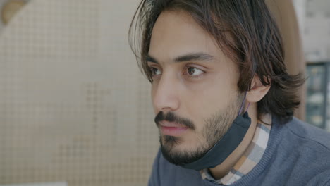 man wearing mask in a cafe