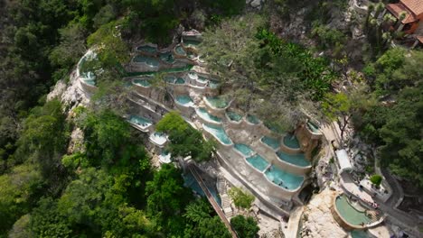 impressive aerial of grutas de tolantongo thermal pools and lush green valley in mexico