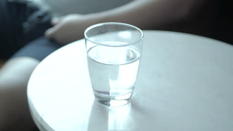 View-to-hand-grap-a-glass-of-water-to-drink-while-relaxing-in-hotel-living-room