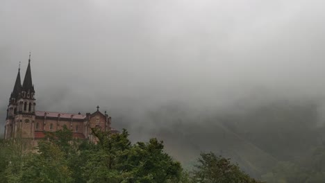 historic basilica in misty mountain setting, covadonga, asturias, spain