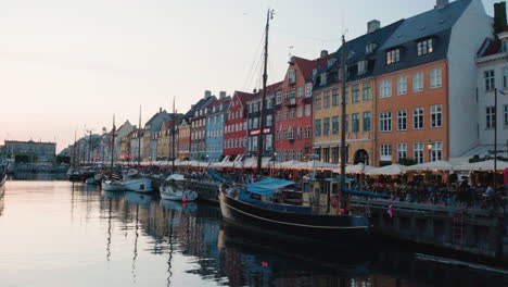 colourful facade of waterfront buildings with boats on nyhavn canal in copenhagen, denmark