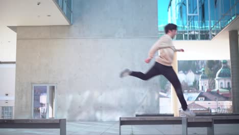 white young adult doing parkour and jumping from bench to bench in 4k