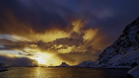 clouds approaching mountainous shore in golden hour