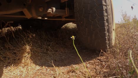 the rear wheels powertrain system of the 4 wheels off road drive light truck driving on dirt and dust ground