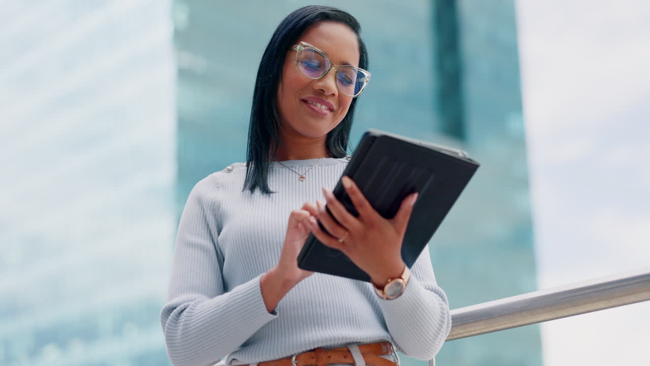 Woman using a tablet outdoors in a city