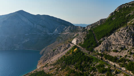 drone flying along the mountainous coastline of the makarska riviera in croatia