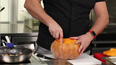 chef preparing a pumpkin for cooking