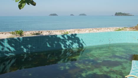 left pan shot shot of a empty swimming pool at a abandoned beach bungalow resort on koh chang island in thailand