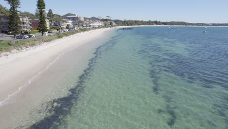 Crystal-Clear-Water-And-Sandy-Shoreline-Of-Shoal-Bay-Beach-In-Port-Stephens,-NSW,-Australia