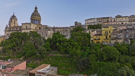 Toma-Aérea-V8-Elevada-De-Ragusa-Italia-Que-Captura-Encantadoras-Casas-Residenciales-De-La-Ciudad-De-Ibla,-Seguida-De-Una-Vista-Aérea-Inclinada-Hacia-Abajo-Sobre-La-Catedral-De-San-Giorgio---Filmada-Con-Mavic-3-Cine---Junio-De-2023