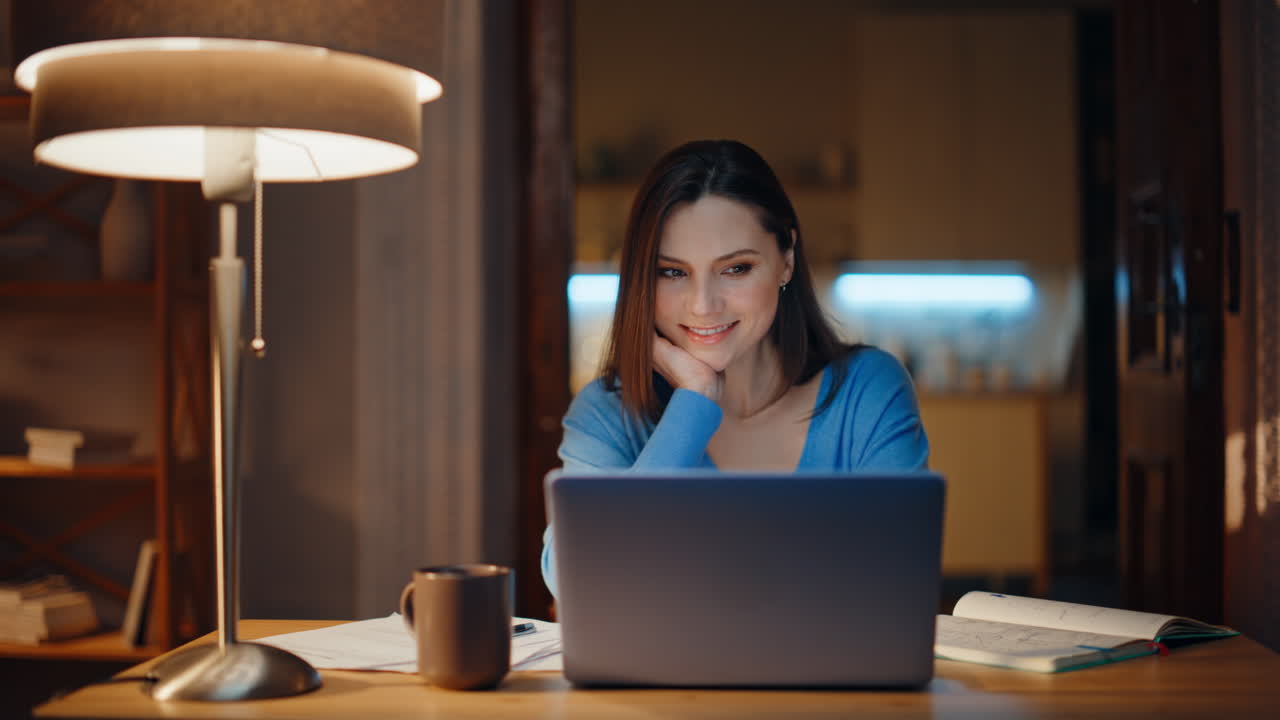 Remote manager working late looking laptop screen satisfied project closeup