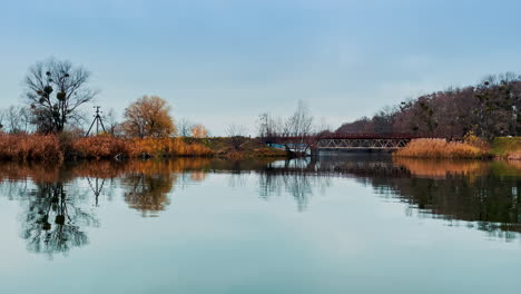 autumn landscape with bridge over river