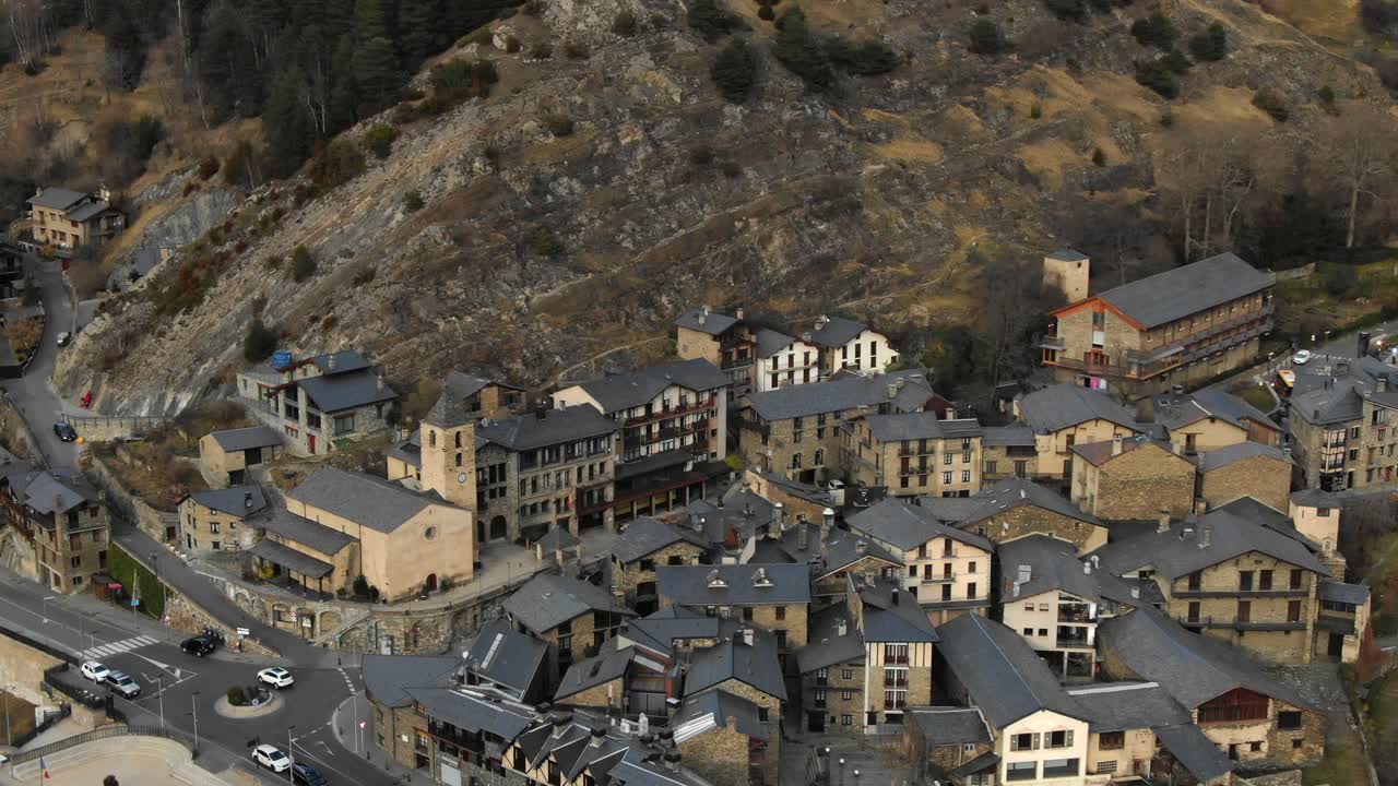 Aerial view of traditional Andorran village buildings and church nestled in mountainside. European alpine architecture, scenic travel spot
