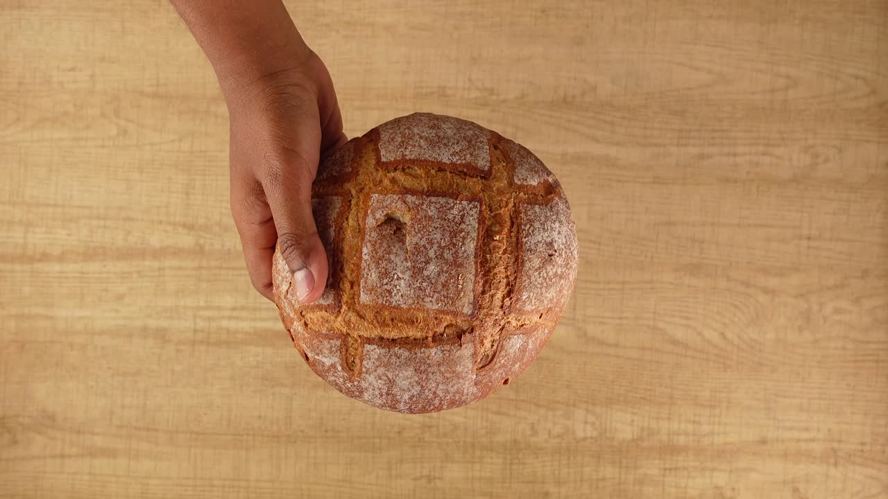 Hands Holding Freshly Baked Sourdough Bread