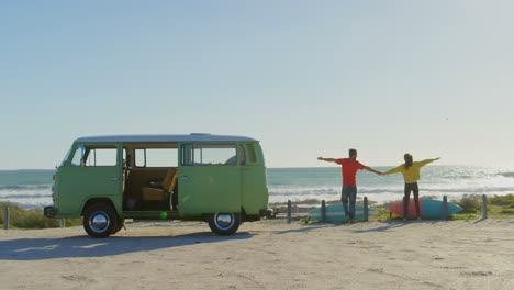 rear view of couple standing with hand in hand at beach on a sunny day 4k