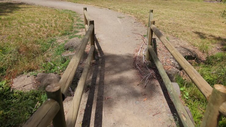 First Person View Walking Over a Small Wooden Bridge