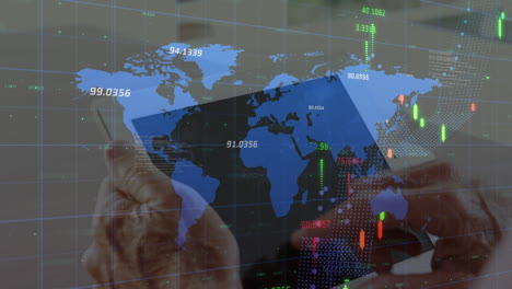 animation of financial data and graphs over hands of caucasian man using tablet