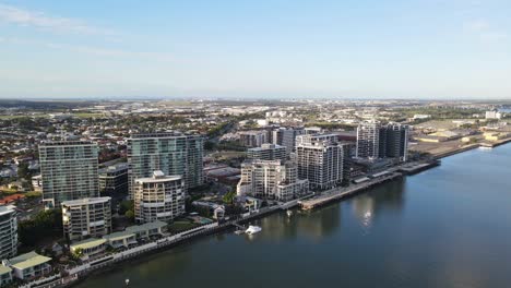 brisbane river with apartment complex on the north bank in brisbane city, qld, australia