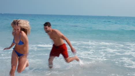 happy cute couple having fun at the beach