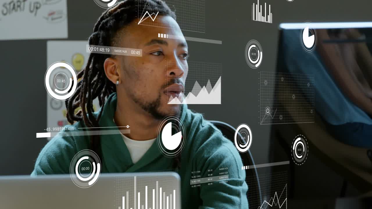 Developer turning toward coworker after ping, manipulating HUD charts on laptop for startup meeting