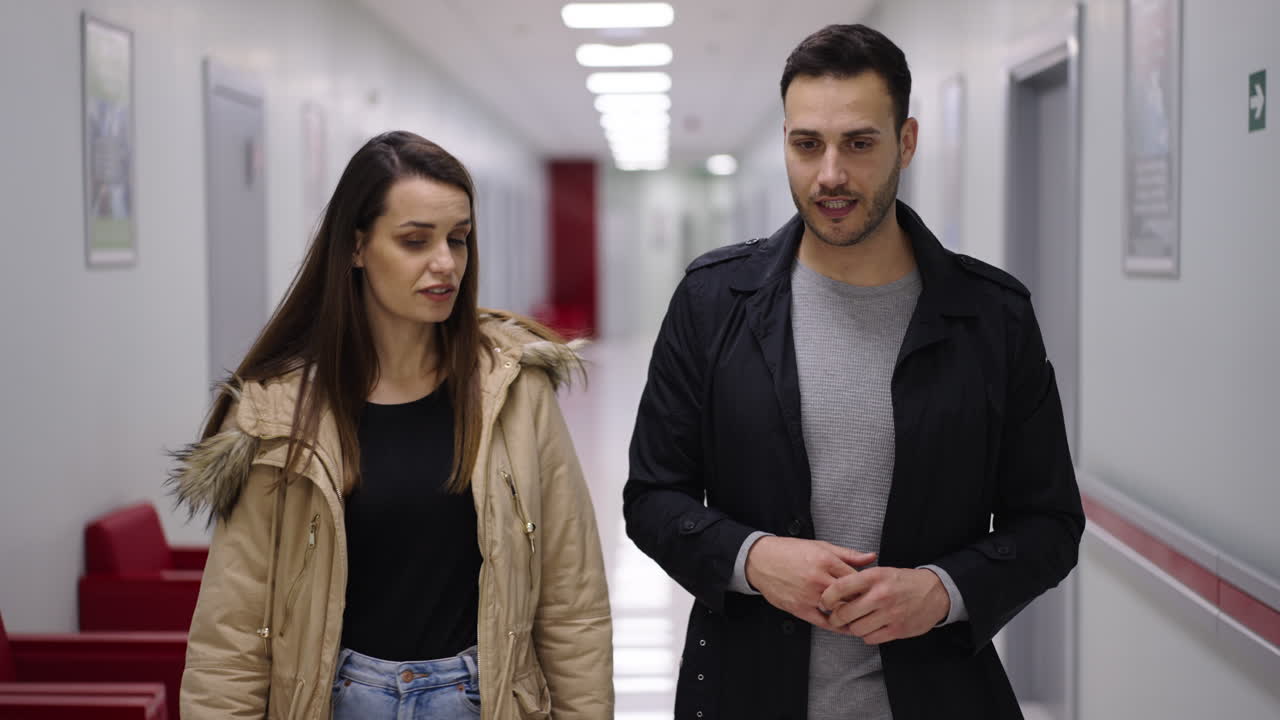 People Walking and Talking in Hallway